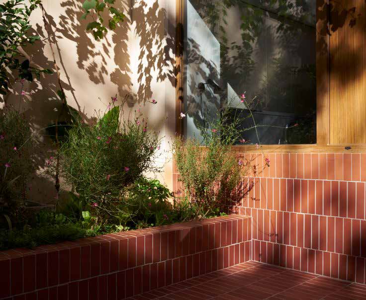 Planted courtyard bench in red handmade brick