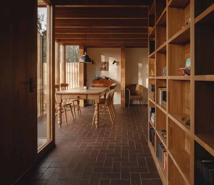 Dining room with timber shelving and clay-tiled floor